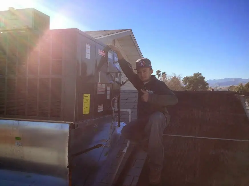 HVAC technician performing AC Tune-Up on a rooftop unit in Soddy-Daisy